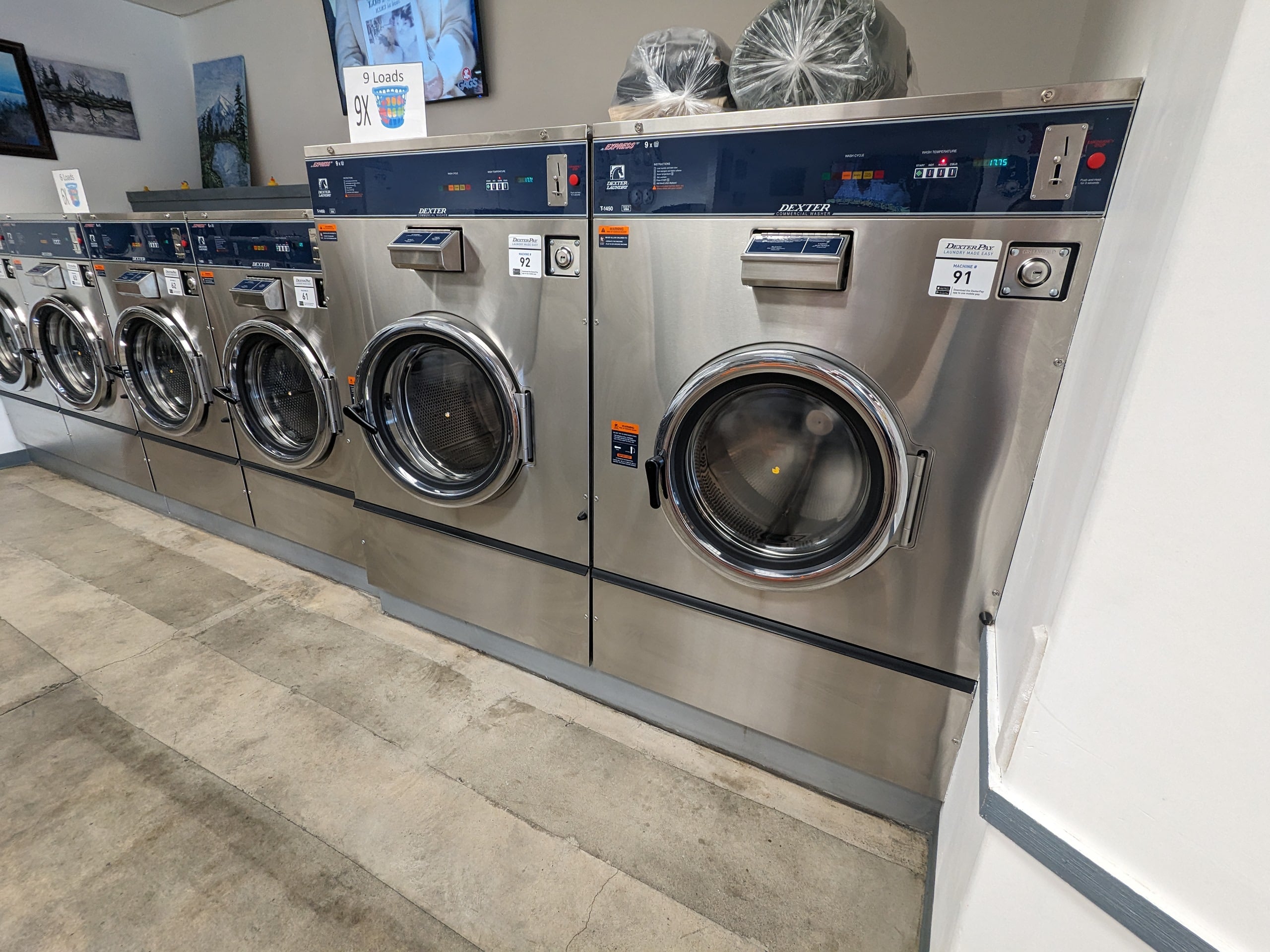 Front-loading commercial washers at Bims Laundry Café