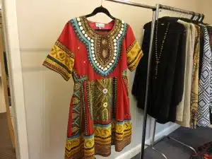Vibrant traditional African dress freshly dry cleaned and hanging neatly at Bims Laundry Cafe in Everett
