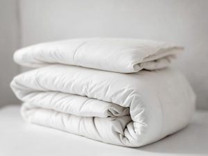 Fluffy white comforter freshly dry cleaned and folded at Bims Laundry Cafe in Mill Creek