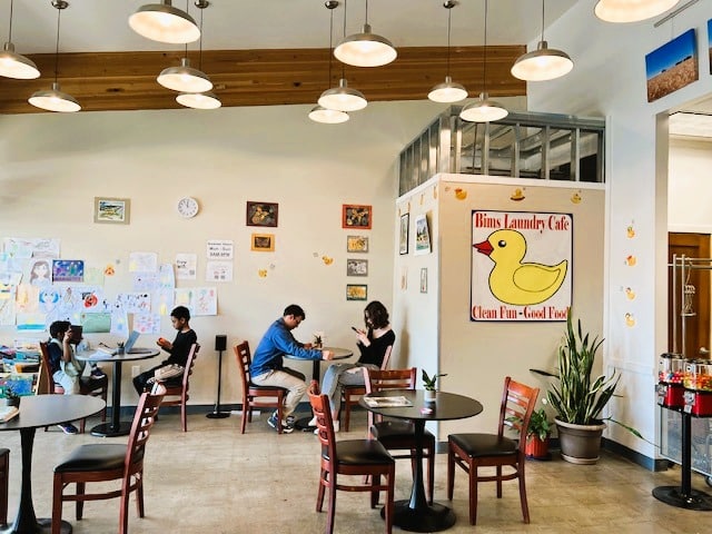 Cafe-style lounge area inside Bims Laundry Cafe in Everett, Washington