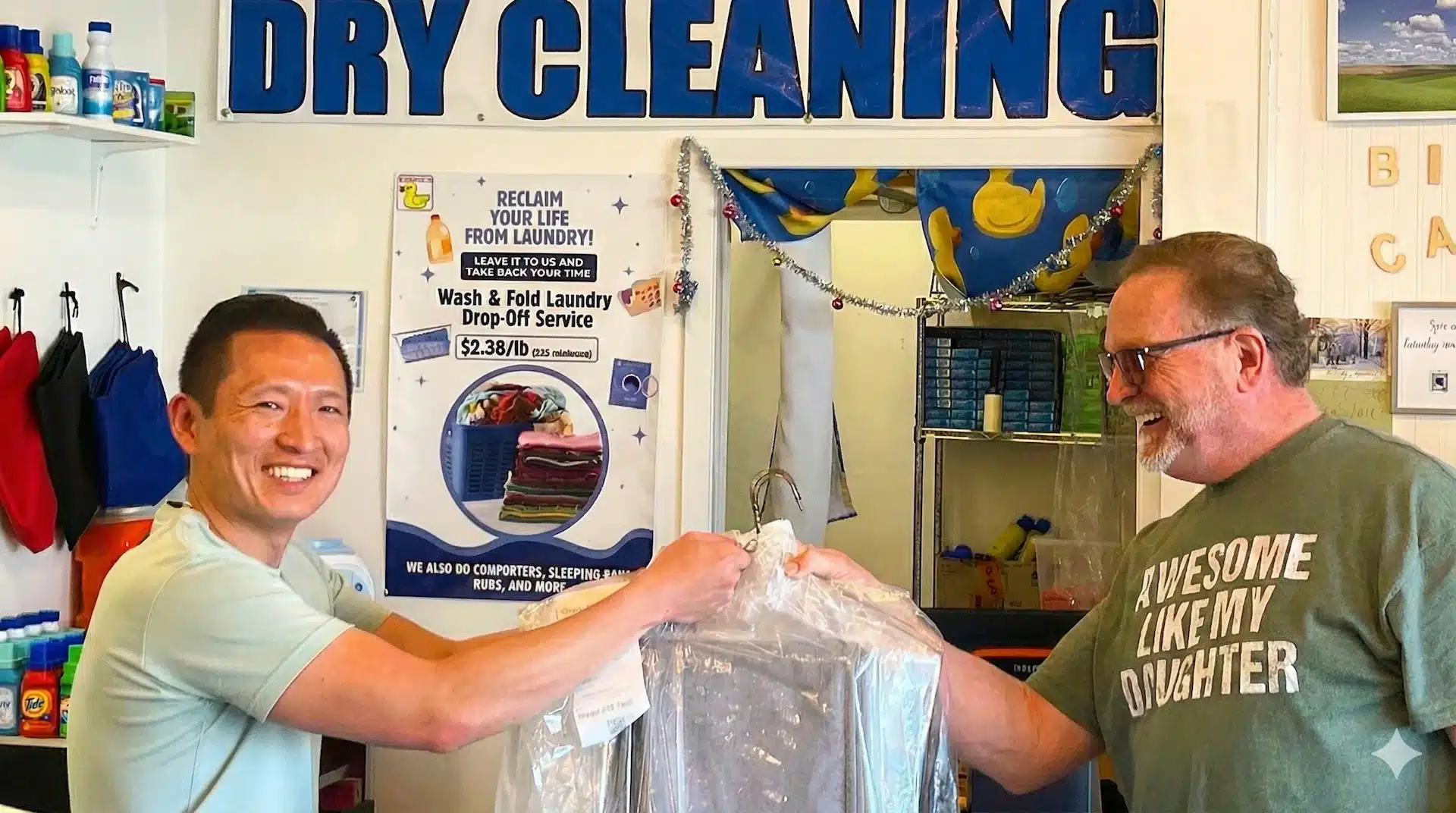 Bims Laundry Cafe team member handing freshly dry cleaned clothes to a smiling customer in Everett with Dry Cleaning sign in background